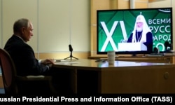 Російський президент Володимир Путін дистанційно бере участь у Всесвітньому російському народному соборі, слухаючи виступ патріарха РПЦ Кирила. 28 листопада 2023 року